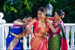 Indian bride being helped by parents to get ready Indian bride being helped by parents to get ready