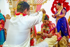 Indian groom pouring rice to bride ritual. Indian groom pouring rice to bride ritual.