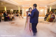 Indian bride and groom dancing during reception party Indian bride and groom dancing during reception party