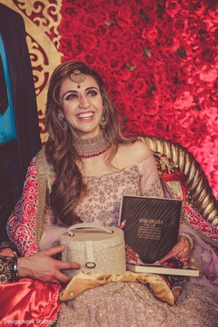 Beautiful bride surrounded by gifts and roses. Beautiful bride surrounded by gifts and roses.