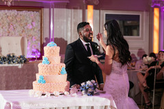 Indian bride and groom sharing a slice of cake. Indian bride and groom sharing a slice of cake.