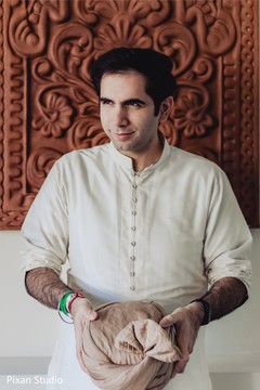 Indian groom about to put his turban on . Indian groom about to put his turban on .
