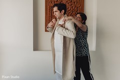 Maharaja getting his sherwani on . Maharaja getting his sherwani on .