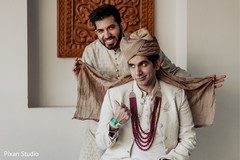 Indian groom getting help to put his turban. Indian groom getting help to put his turban.