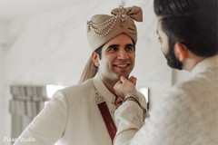 Indian groom getting his jewelry on . Indian groom getting his jewelry on .