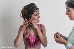 Indian bride getting her earrings on. Indian bride getting her earrings on.
