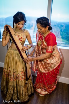Indian bride being assisted by her mother. Indian bride being assisted by her mother.