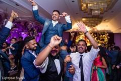 Indian groom being lifted by special guests Indian groom being lifted by special guests