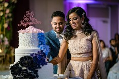 Indian bride and groom cutting the cake. Indian bride and groom cutting the cake.