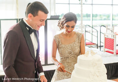 Lovely capture Indian bride and groom cutting cake together. Lovely capture Indian bride and groom cutting cake together.