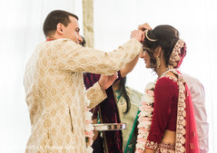 Indian groom putting the red mark on maharanis forehead. Indian groom putting the red mark on maharanis forehead.