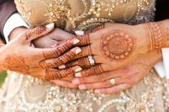 Indian bride and groom showing their wedding rings. Indian bride and groom showing their wedding rings.
