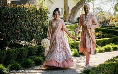 Indian bride and groom outdoors during pictures. Indian bride and groom outdoors during pictures.