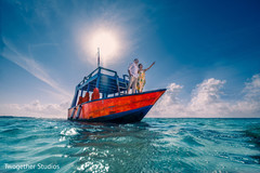 Bride and groom riding a boat. Bride and groom riding a boat.