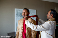 Indian groom getting help to put on the Dupatta. Indian groom getting help to put on the Dupatta.