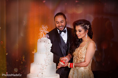 Indian wedding cutting the cake scene. Indian wedding cutting the cake scene.