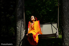 Enchanting Indian bride on a swing seat outdoors. Enchanting Indian bride on a swing seat outdoors.