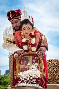 Indian couple pouring rice at wedding ceremony. Indian couple pouring rice at wedding ceremony.