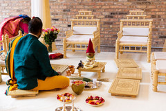 Officiant at mandap preparations capture. Officiant at mandap preparations capture.