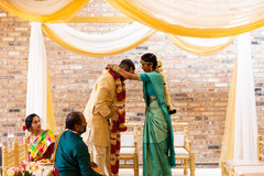 Indian bride putting flower garland to groom. Indian bride putting flower garland to groom.