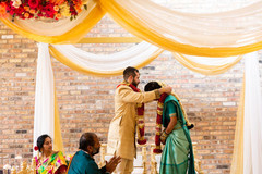 Indian groom putting flower garland to bride Indian groom putting flower garland to bride