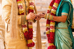 Closeup capture of Indian wedding exchange rings ritual.