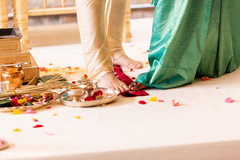Indian bride and groom stepping on the nuts ritual.