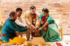Sweet Indian couple making offerings to sacred fire.