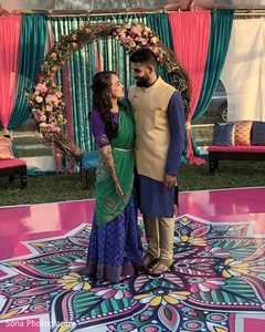 Lovely Indian couple posing on sangeet outfits. Lovely Indian couple posing on sangeet outfits.
