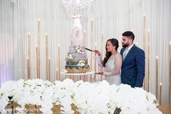 Dreamy Indian wedding cutting the cake scene. Dreamy Indian wedding cutting the cake scene.