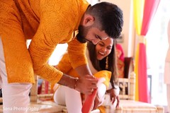 Indian groom putting red paint on maharanis foot. Indian groom putting red paint on maharanis foot.