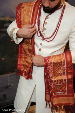 Closeup capture of Indian groom getting his dupatta on. Closeup capture of Indian groom getting his dupatta on.