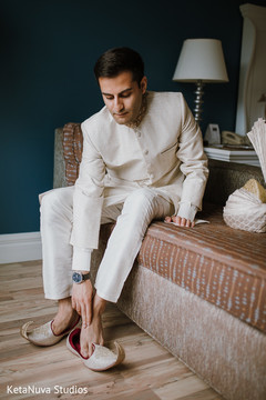Indian groom putting on elegant shoes. Indian groom putting on elegant shoes.