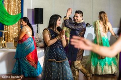 Joyful Indian couple dancing at sangeet. Joyful Indian couple dancing at sangeet.