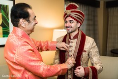 Indian groom getting ready and being helped by his father. Indian groom getting ready and being helped by his father.