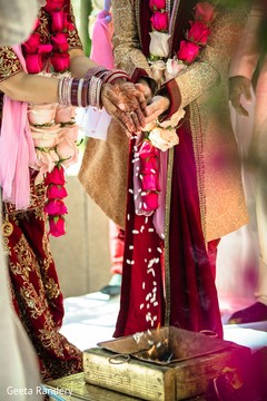 Indian couple dropping rise into the fire. Indian couple dropping rise into the fire.