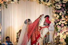 Indian bride putting flower garland to groom Indian bride putting flower garland to groom