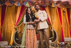 Marvelous Indian couple posing at sangeet stage. Marvelous Indian couple posing at sangeet stage.