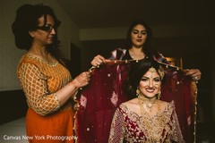 Indian bride being helped to put her Ghoonghat.. Indian bride being helped to put her Ghoonghat..