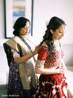 Indian bride getting her lehenga on . Indian bride getting her lehenga on .