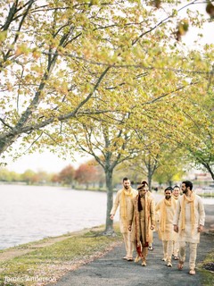 Charming Indian groom with groomsmen walking outdoors. Charming Indian groom with groomsmen walking outdoors.