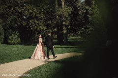 Indian groom and bride walking outside. Indian groom and bride walking outside.