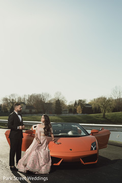 Indian bride and groom posing with the car. Indian bride and groom posing with the car.