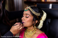 Indian bride getting her wedding makeup done Indian bride getting her wedding makeup done