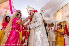 Indian bride putting flower garland to groom Indian bride putting flower garland to groom