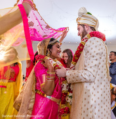 Indian groom putting flower garland to bride Indian groom putting flower garland to bride