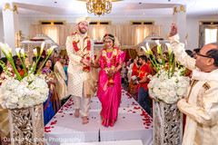 indian bride and groom walking out from the ceremony stage indian bride and groom walking out from the ceremony stage