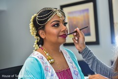 Bride being dolled up by makeup artist. Bride being dolled up by makeup artist.