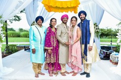Indian couple posing with relatives at mandap. Indian couple posing with relatives at mandap.