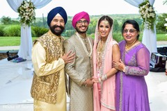 Lovely Indian couple posing with parents. Lovely Indian couple posing with parents.